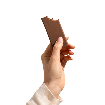 A hand holding a Choc Fudge Bar by Good Betty. 