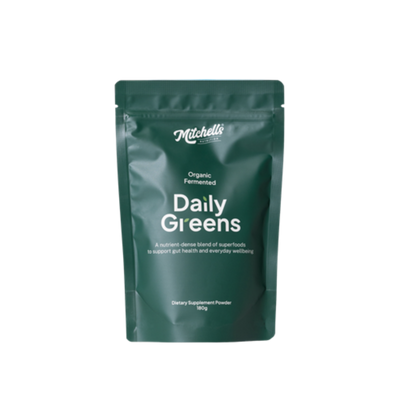 A Supplement container with the name  Daily Greens by Mitchell's Nutrition.